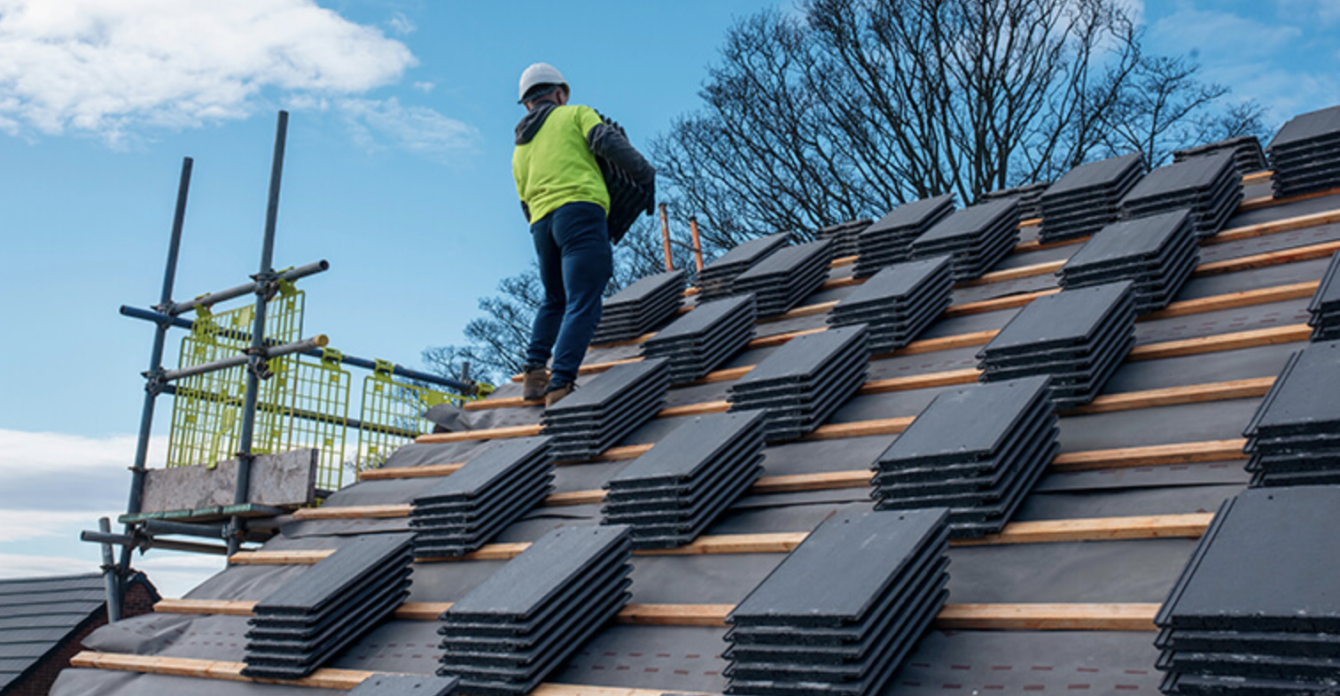 Roofer installing tiles